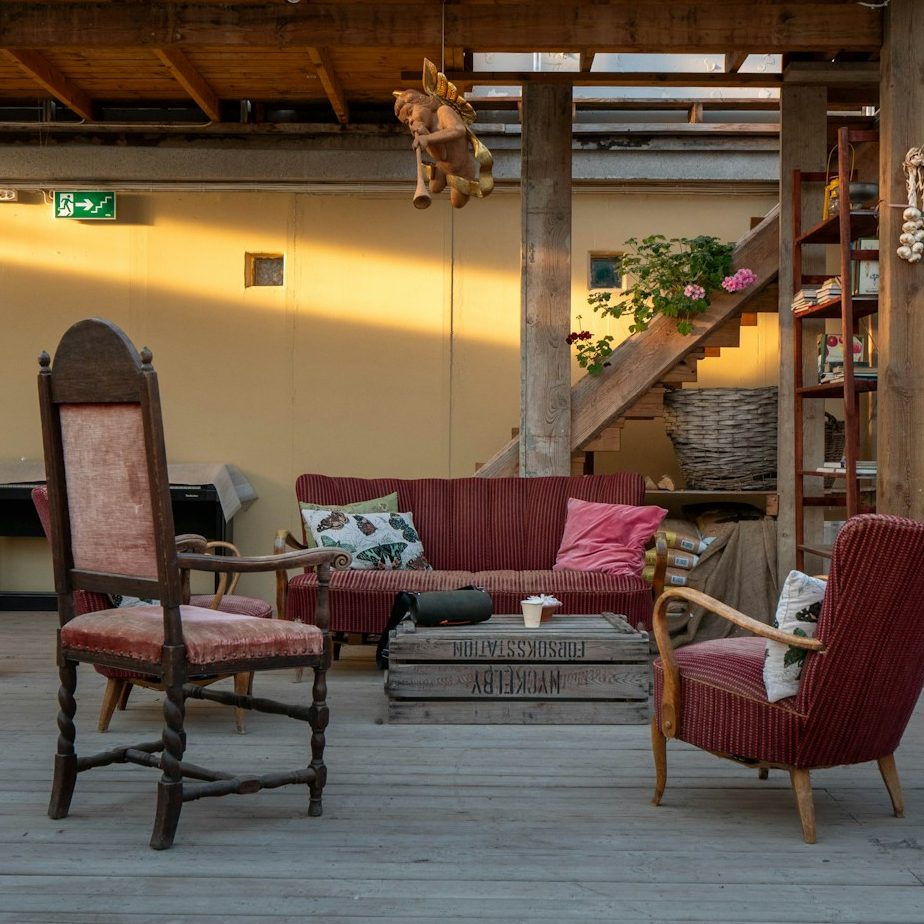Covered patio living space with rustic seating and exposed timber framing