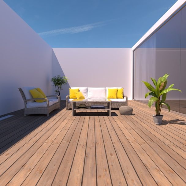 Modern wooden deck with wicker patio furniture and potted plant